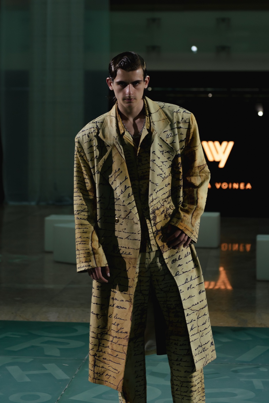 Akasha runway, manuscript-print coat by the pool