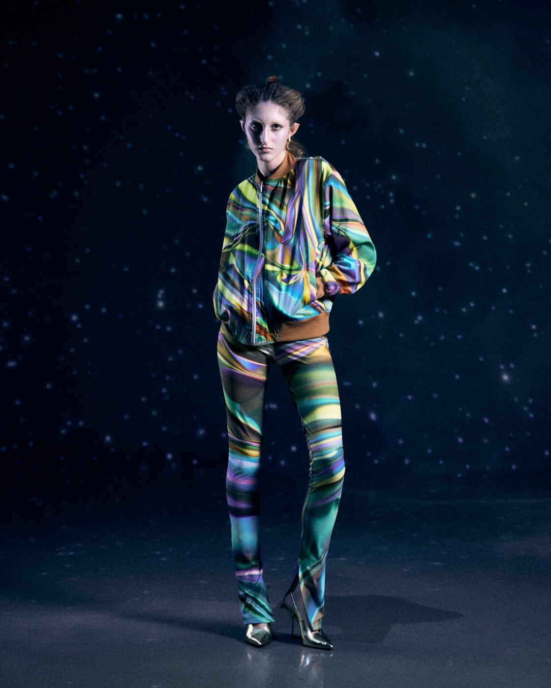 Origin campaign, rainbow-striped jumpsuit under starfield
