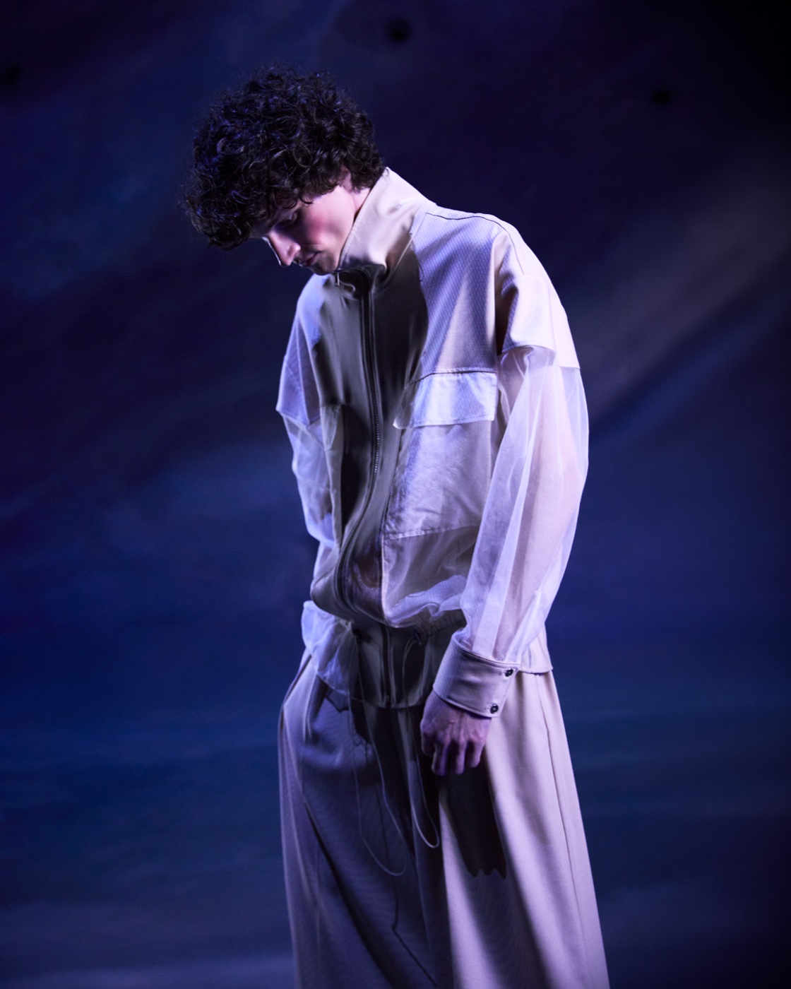 Origin campaign, beige jacket and trousers against nebula