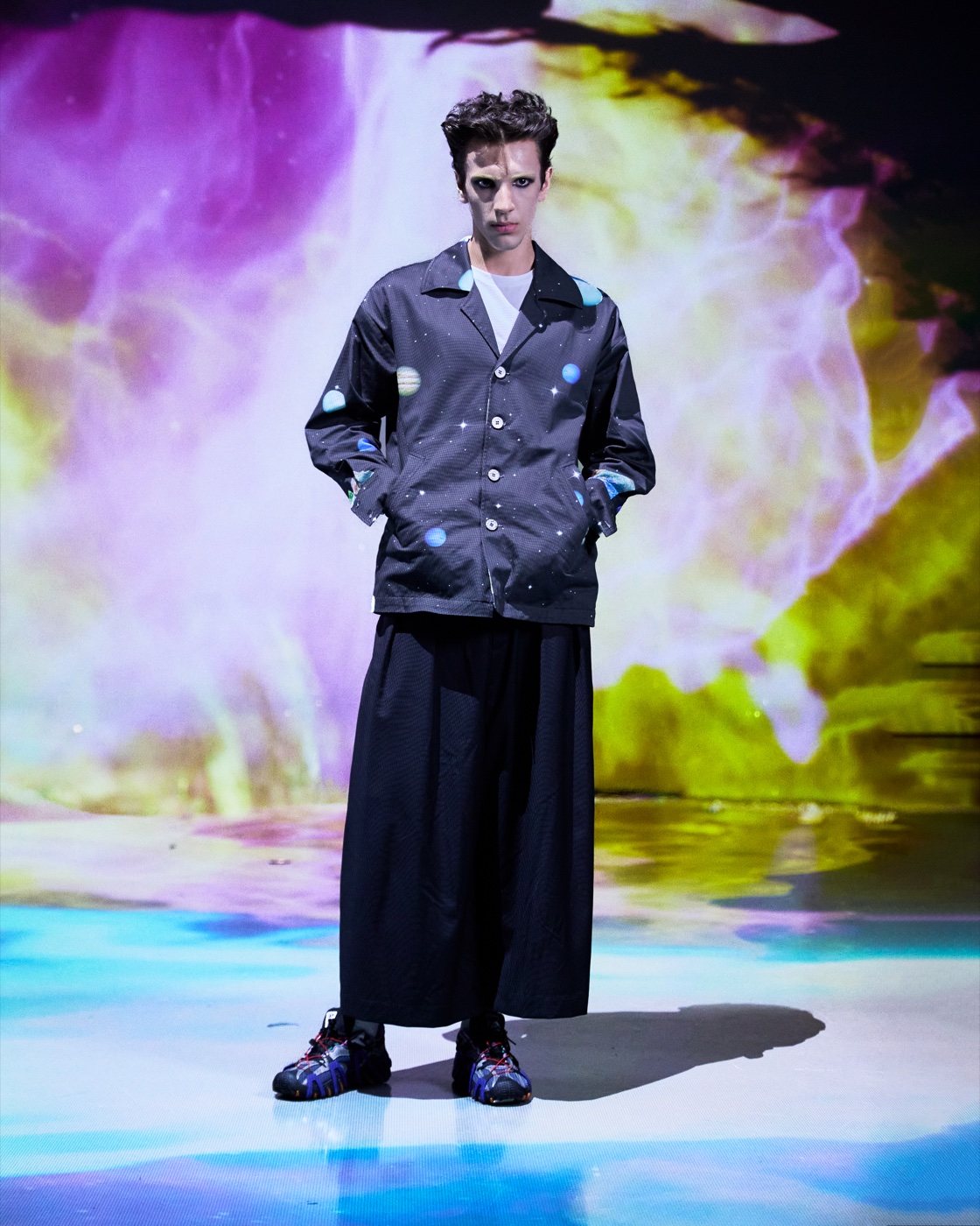 Origin campaign, jacket and wide trousers against colourful smoke