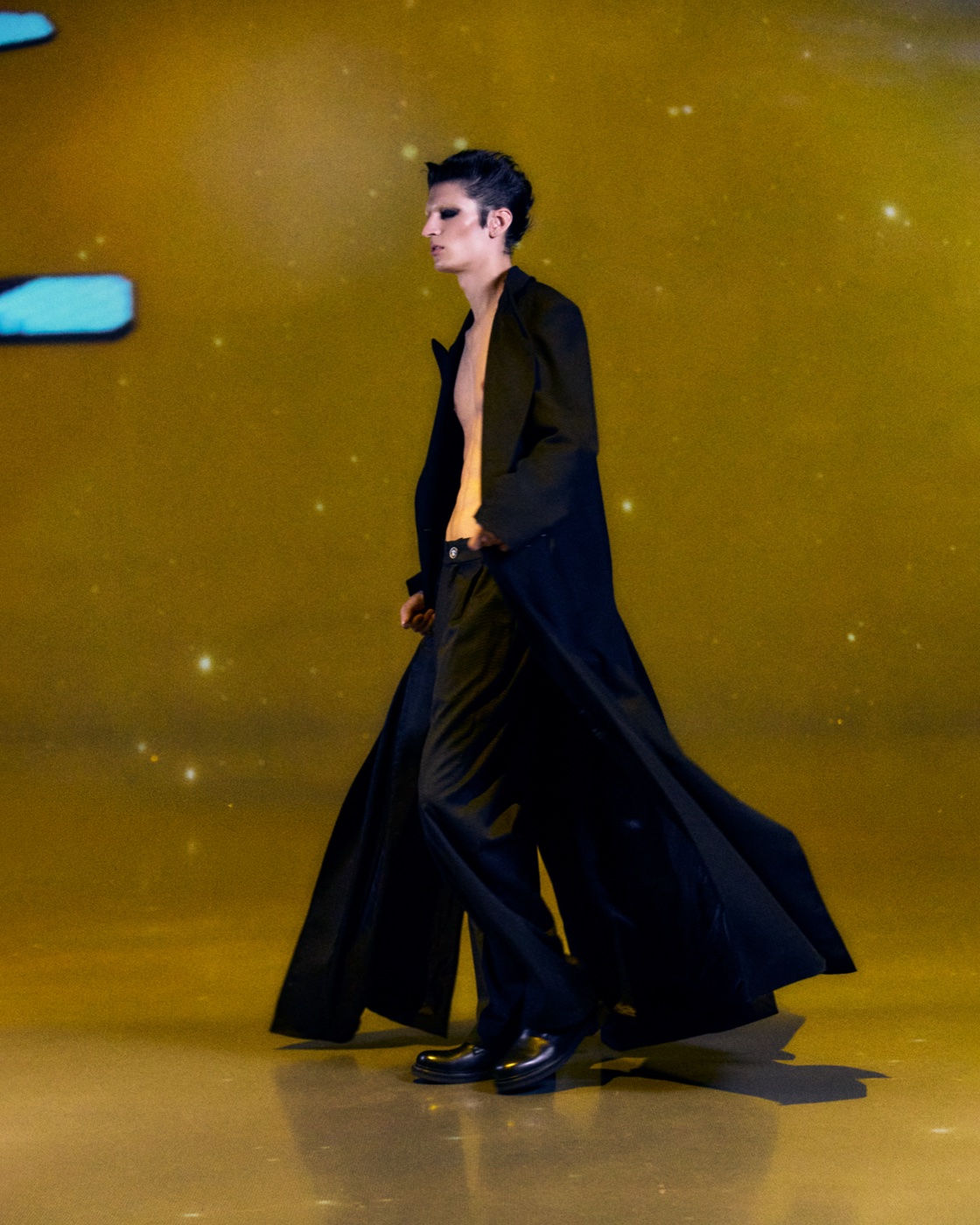 Origin campaign, open coat in motion under golden light