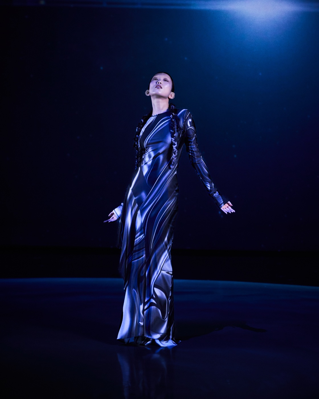 Origin campaign, galaxy-print dress under spotlight