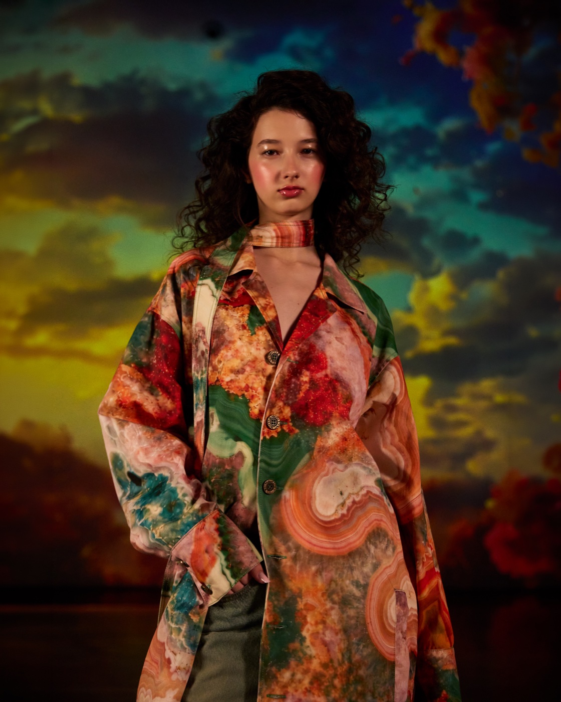 Origin campaign, tropical floral coat against sunset sky
