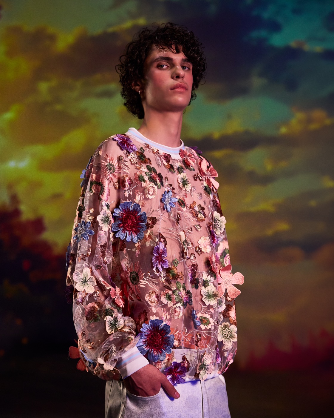 Origin campaign, floral embroidered sweatshirt against sunset sky