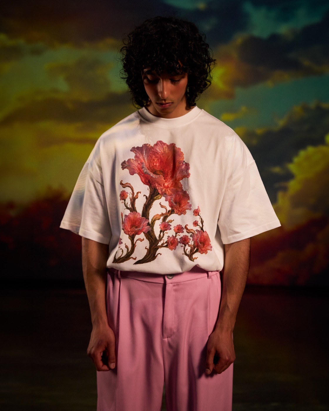 Origin campaign, floral t-shirt and pink trousers against sunset sky